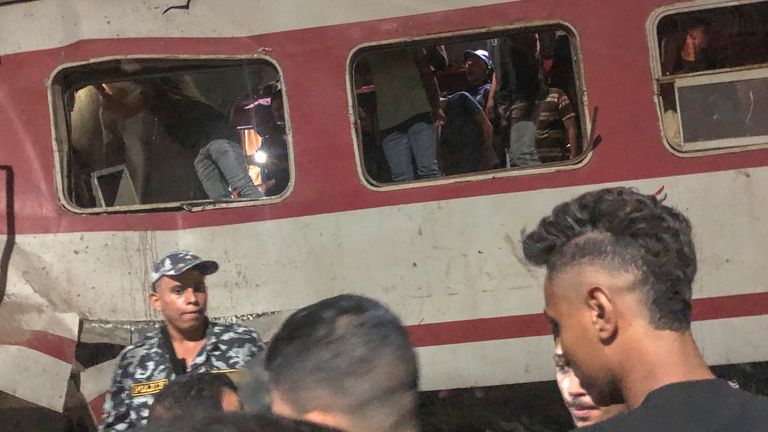 People surround a passenger train which collided with another one. Pic: AP