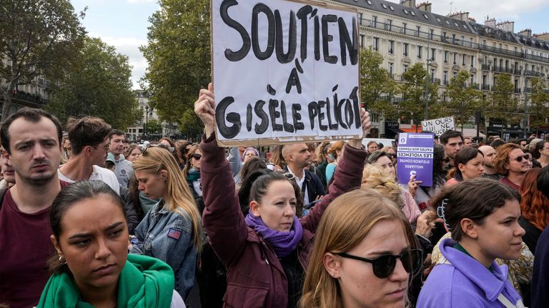 People take part in a gathering in support of 71-year-old Gisele Pelicot who was allegedly drugged by her ex-husband and raped by dozens of men while unconscious, Saturday, Sept. 14, 2024 in Paris. Placard reads, "support for Gisle Pelicot." (AP Photo/Michel Euler) 